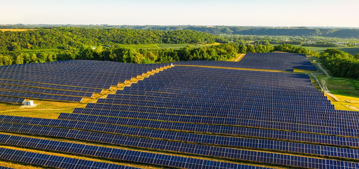 Aerial view of a solar farm in the Upper Midwest at golden hour