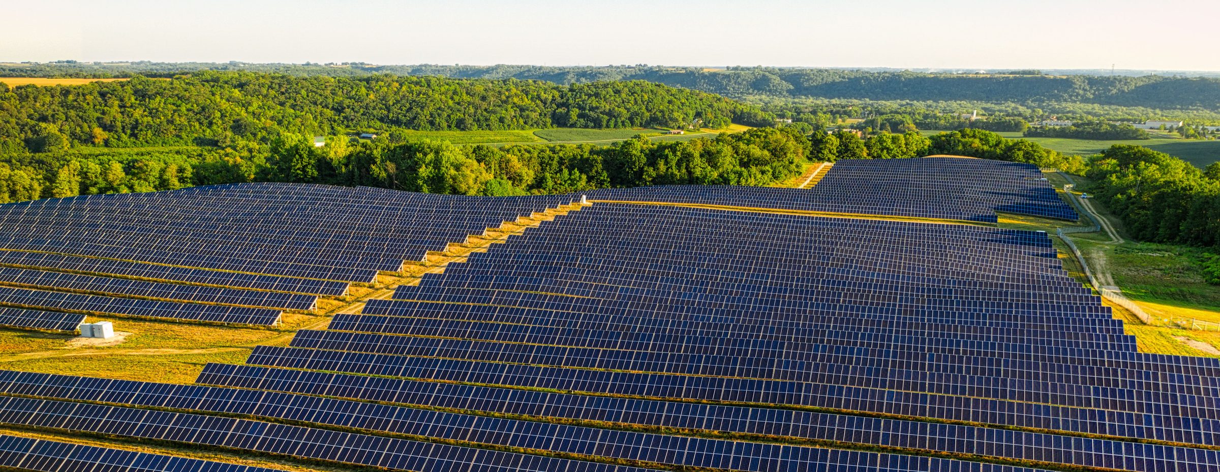 Aerial view of a solar farm in the Upper Midwest at golden hour